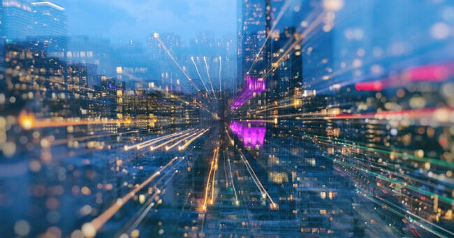 Areal view of dazzling Toronto cityscape during a blue hour using long exposure, zooming in bokeh mode.